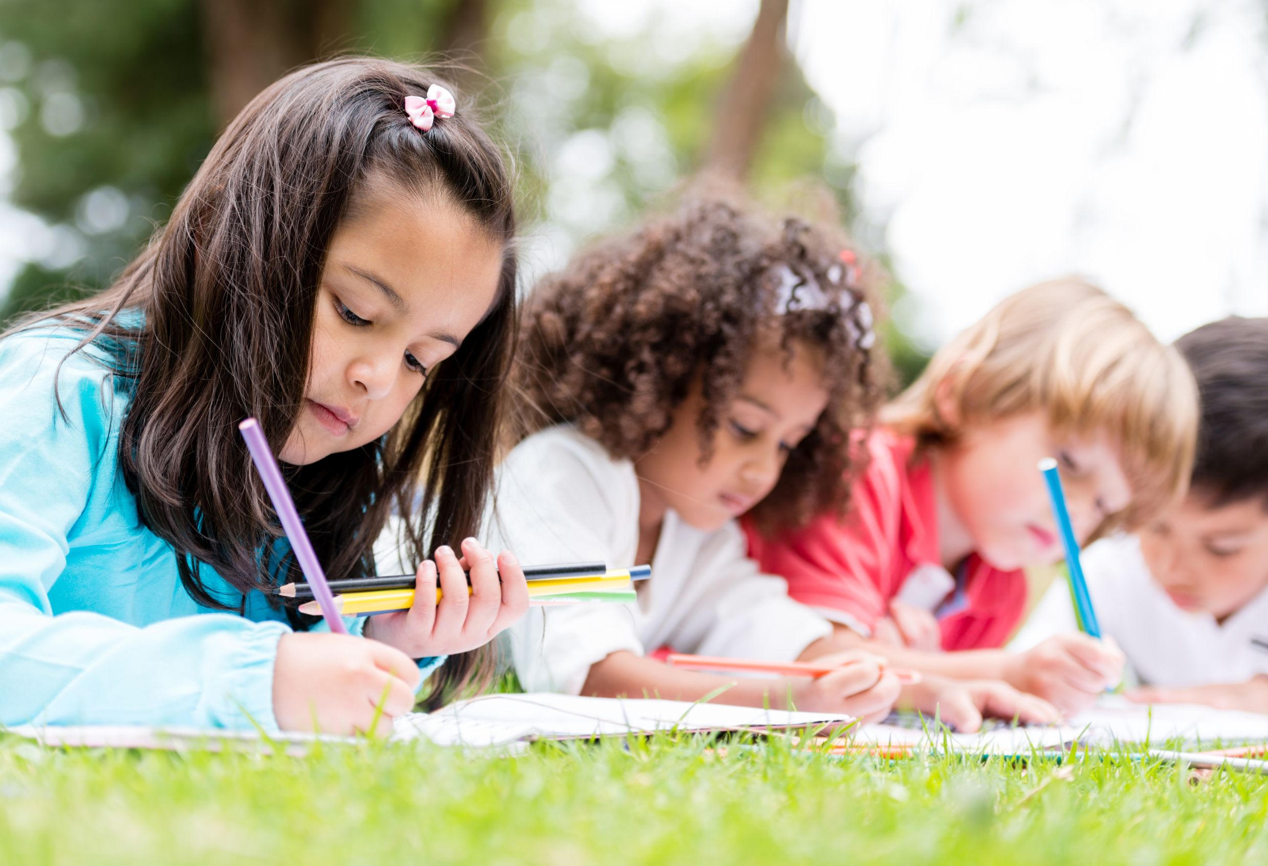 21788266 - happy group of children coloring at the park